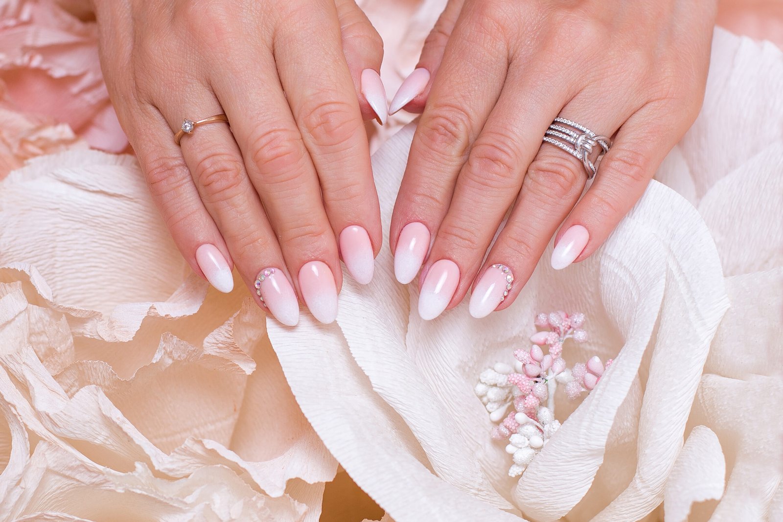 female hands with ombre manicure nails pink gel polish scaled